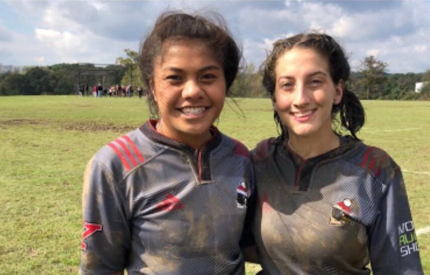 Former player Laelae Amituanai and president Hannah Hall pose together for a picture after a muddy match.